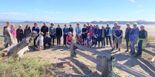 A large group of women on a beachside trail.