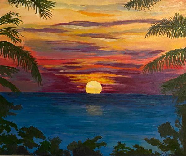 Florida sunset over ocean with palm trees and purple, red and orange sky behind the sun.