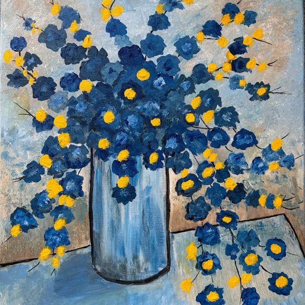 Blue and yellow flower in tall vase on table. Cheerful and happy.