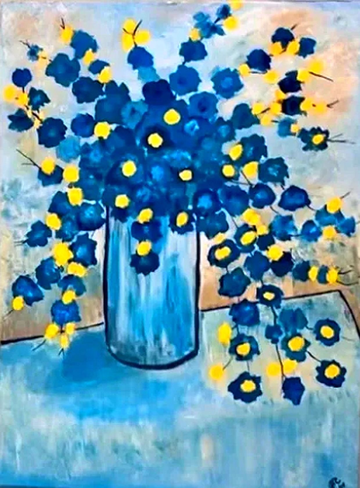 Blue and yellow flowers in vase on table