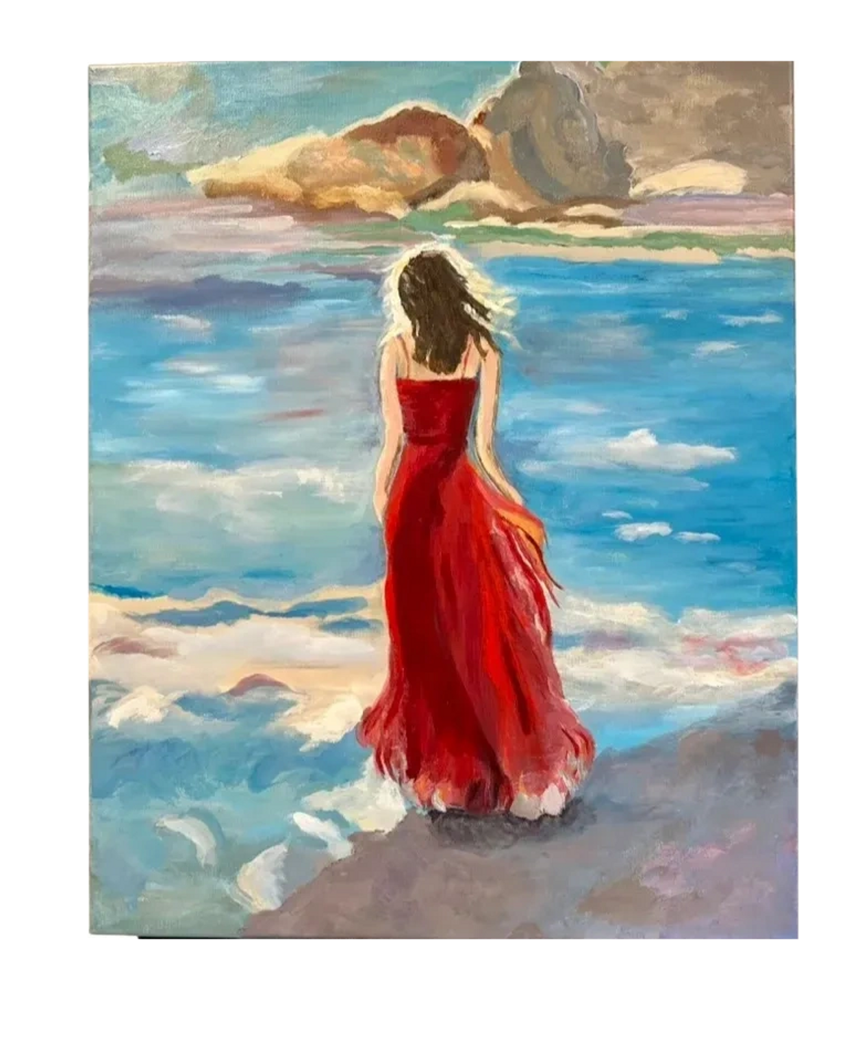 Woman in flowy red dress looking out at the water's edge.