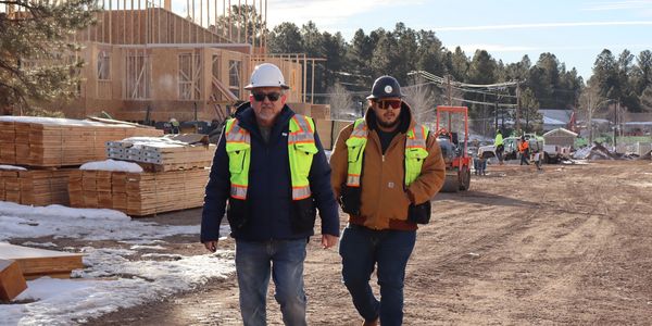A two man walking construction site