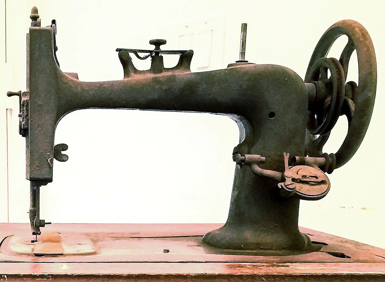 A rusty, dusty sewing machine built in the late 1800s.  All identifiable markings worn away.