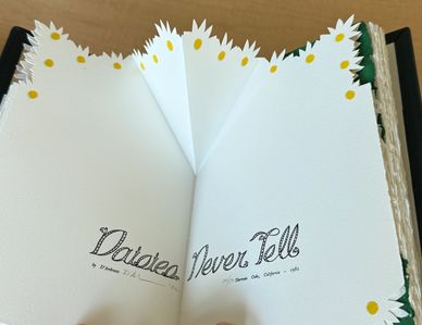 Artistic book with scalloped pages and handwritten title.