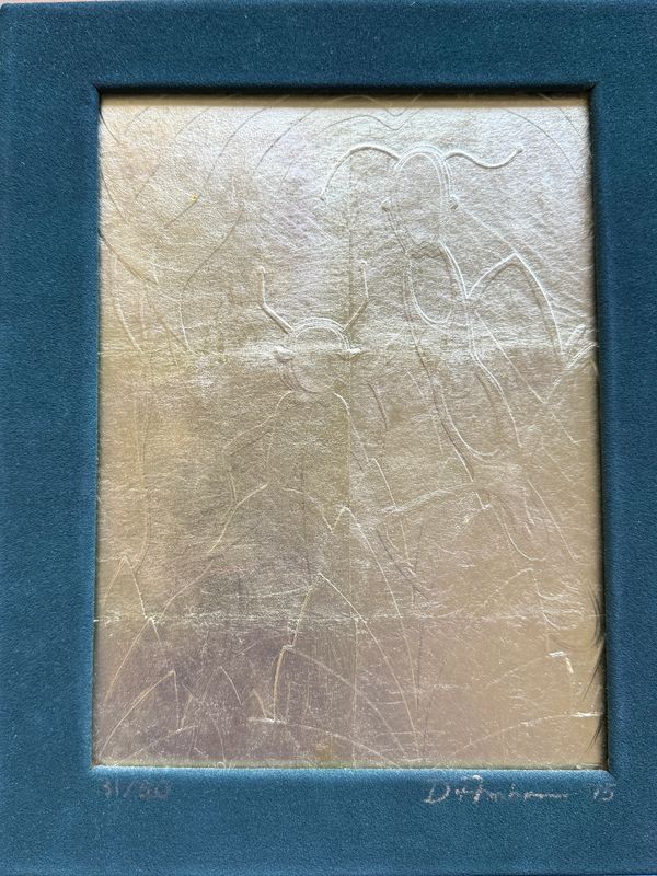 Framed embossed artwork with abstract figures on a metallic gold sheet.