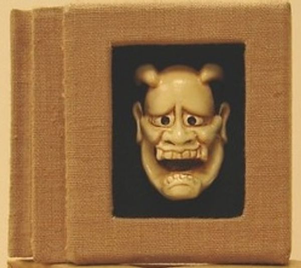 A traditional Japanese Noh mask with a worried expression.