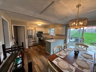 Bright, modern kitchen and dining area with wooden floors.