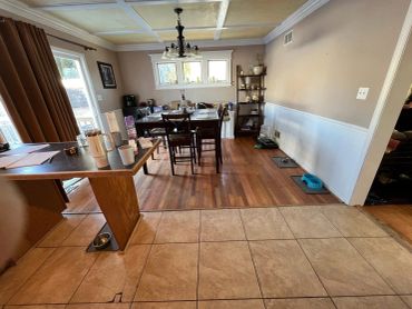Dining area with hardwood and tile flooring.