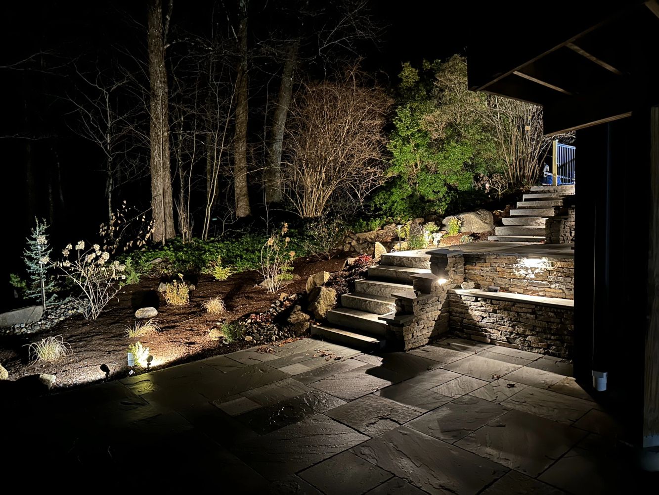 Outdoor stone steps illuminated at night.