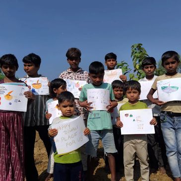 Group of children holding handmade posters outdoors under a clear sky.