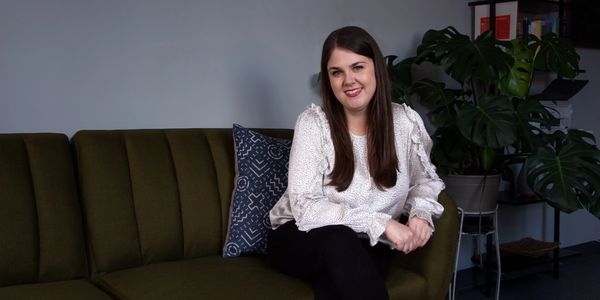 Sydney getting cozy on the couch in our office that clients often sit in.
