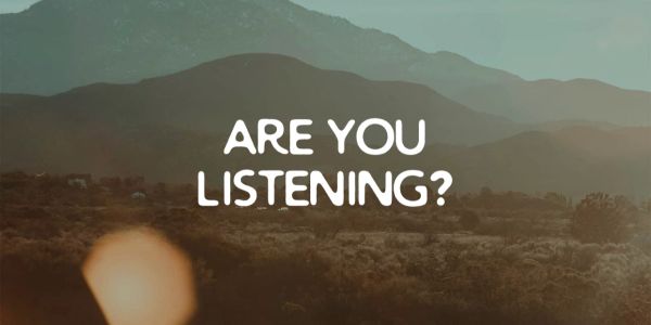 Scenic mountain view with text asking, 'Are you listening?'