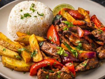 Plato con carne, papas, arroz y vegetales.