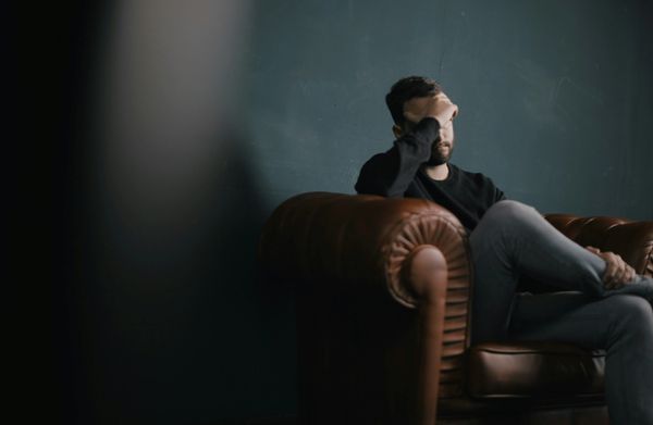 Man feeling overwhelmed by stress and pressure before counselling