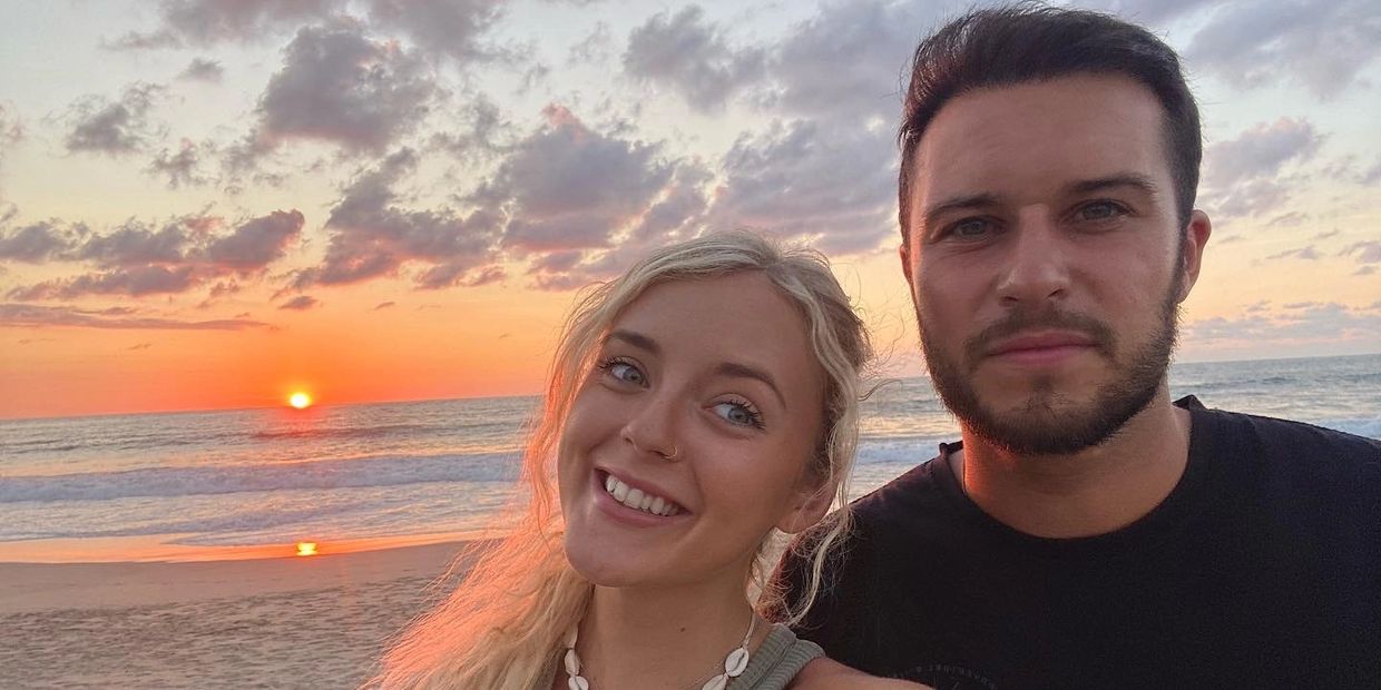 Owners of Barefoot Boardriders, Taylor & Jack on a beach in Mexico with the sunset behind them