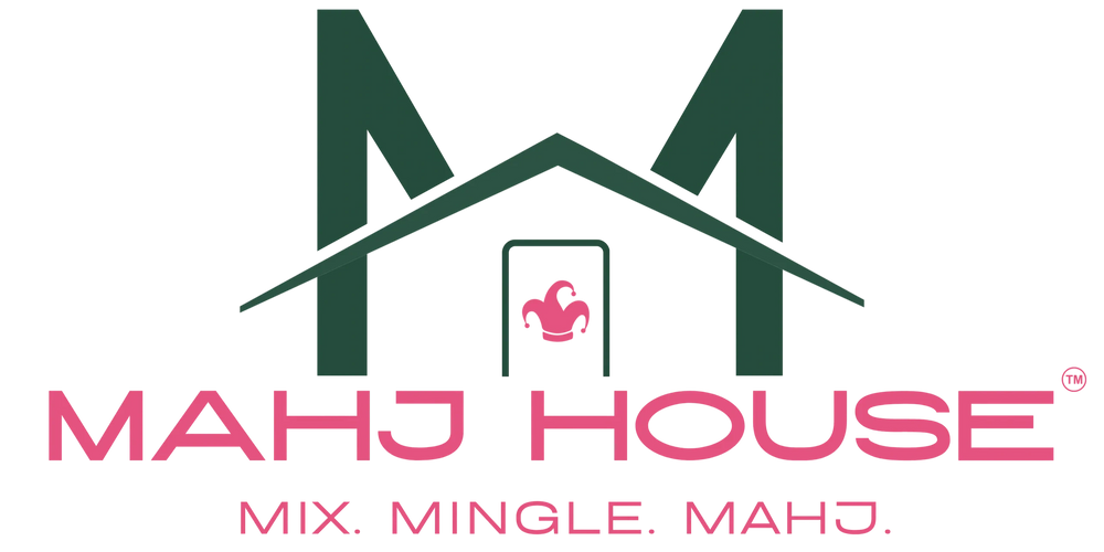 Stack of books next to pencils in a holder and a camera.