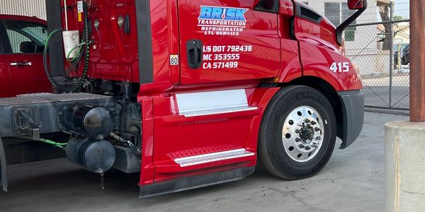 Close-up of red Brisk Transportation truck front side.