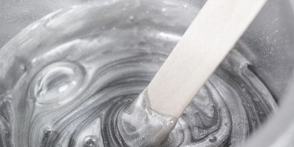 Stirring Hard Wax in Waxpot