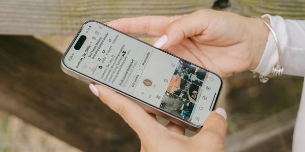 photo of a woman holding a phone showing an instagram page