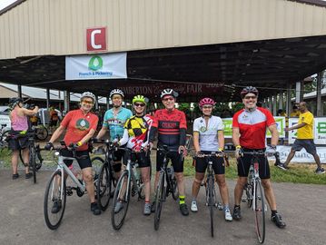 Group of cyclists with bikes.  