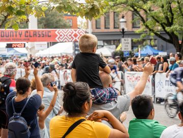 Crowds cheering at a bike race. 