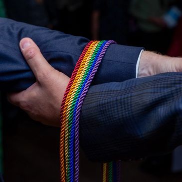 Southville celebrant. PRIDE rainbow coloured braids as part of a handfasting ceremony in Bristol