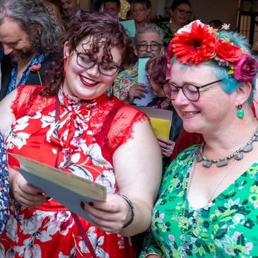 Southville celebrant. Guests sing along at wedding ceremony at the Square Club, Clifton, Bristol.