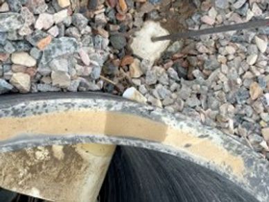 Foam injection sealing manhole pipe infiltration to stop soil intrusion and groundwater leaks.