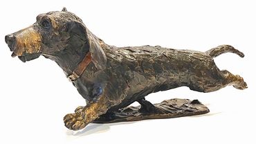 A bronze sculpture of a shaggy dog