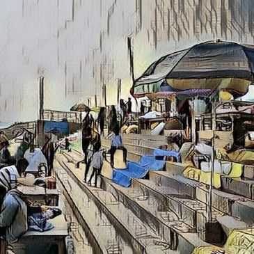 People sitting and walking on steps near a riverside with umbrellas.