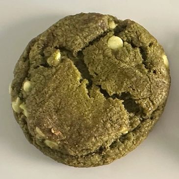 Close-up of a green matcha cookie with white chocolate chips.