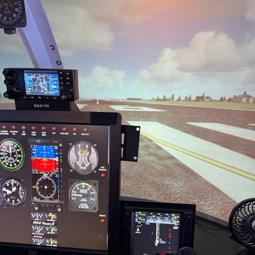 Flight simulator cockpit with runway view and instrument panels.