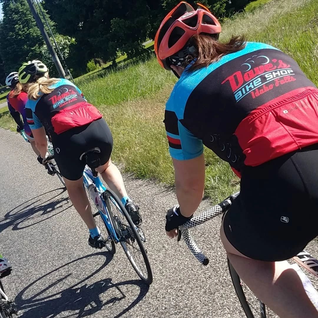 Women riding bicycles sporting Dave's Bike Shop Jerseys