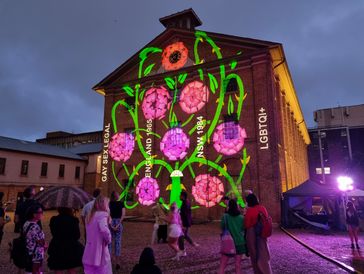 Lightartwork projected onto Hyde Park Barracks text: 'Gay Sex Legal England 1964, NSW 1984, LGBTQI+
