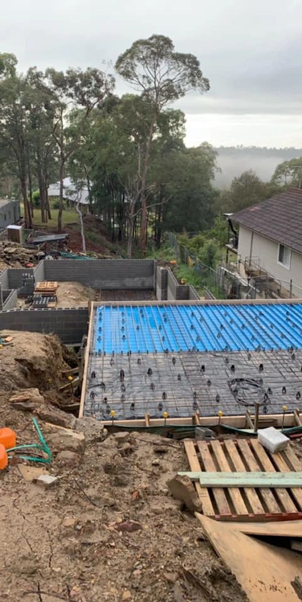 house slab with foundation work and steel in ready for pour tomorrow also some nice surrounding tree