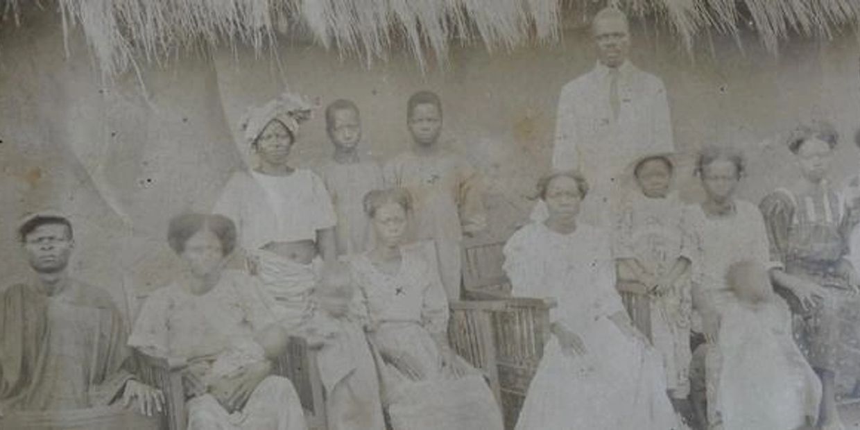 Vintage group portrait of men and women in traditional attire.