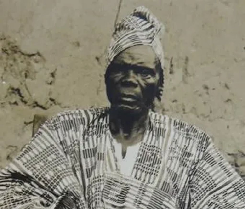 Portrait of an elderly African man in traditional attire.