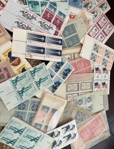 Pile of Old Postage Stamps Sitting on Top of a Table