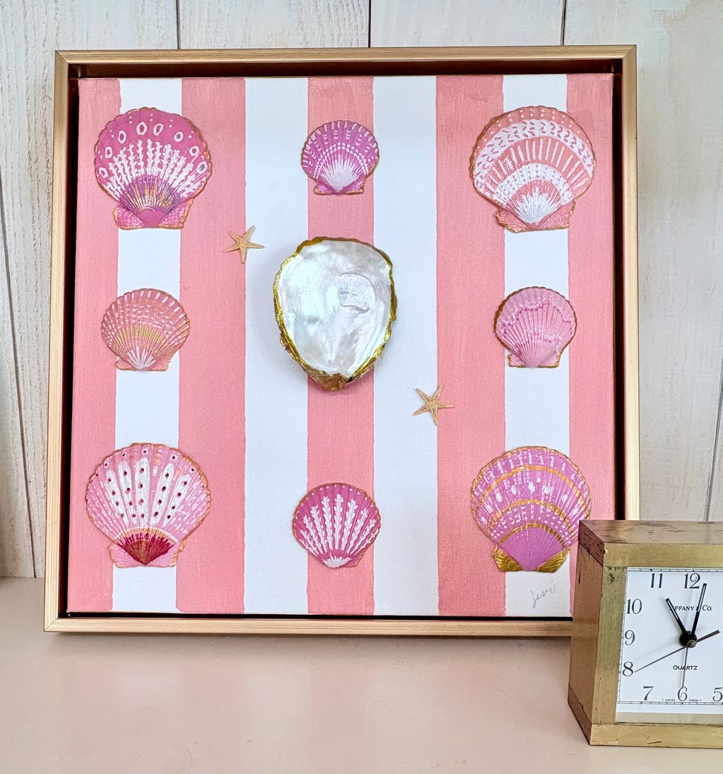 Artwork with pink shells on striped pink and white background.