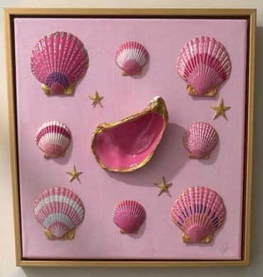 Pink seashells and starfish on a pink background in a frame.