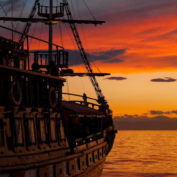 Pirate ship sailing into sunset