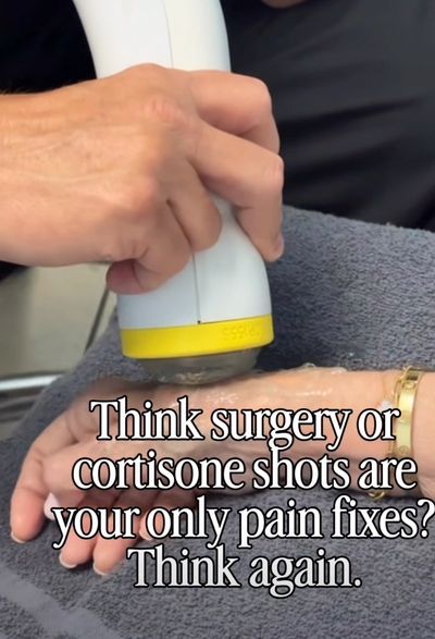 SoftWave therapy being performed on a hand. 