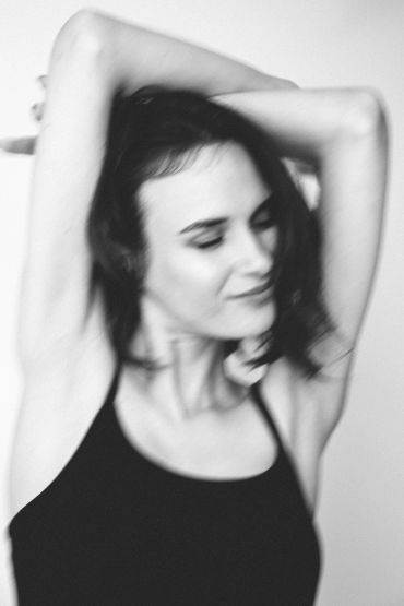 Woman stretching with eyes closed.