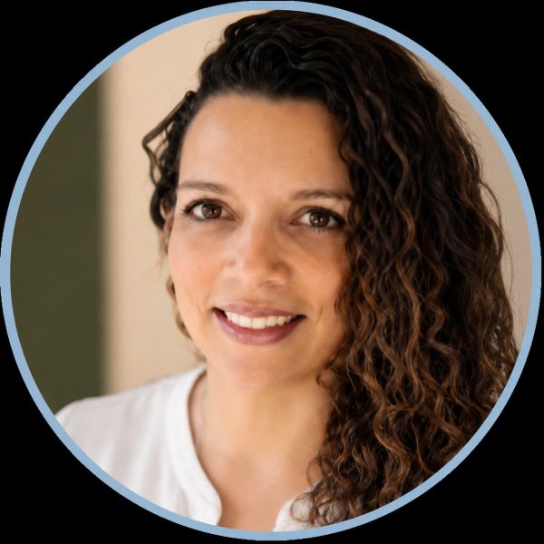Portrait of a smiling woman with curly hair.