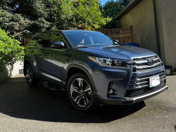 A dark gray Toyota SUV parked on a driveway.