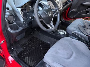 Interior of a Honda car showing steering wheel and front seats.
