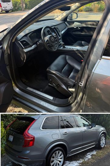 Gray Volvo SUV with black leather interior parked outdoors.
