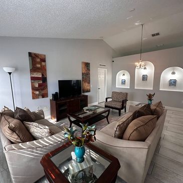 Cozy living room with beige sofas and elegant wooden furniture.