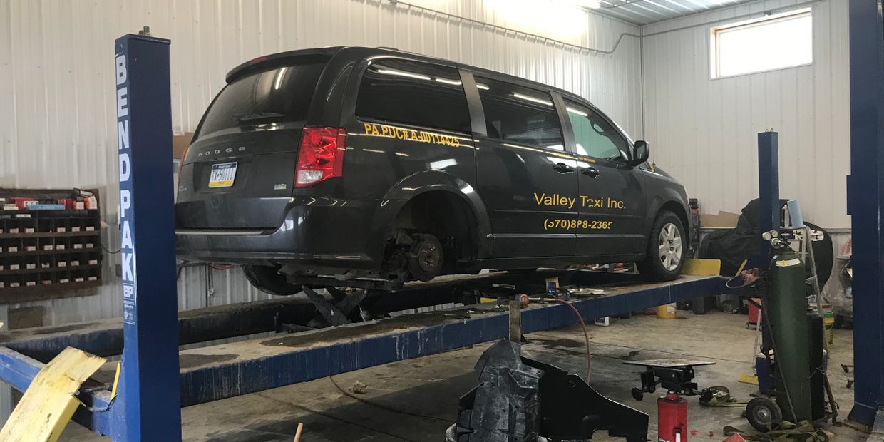 A car on the service stand at the repair shop