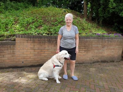 Lady with golden Retriever sitting beside her